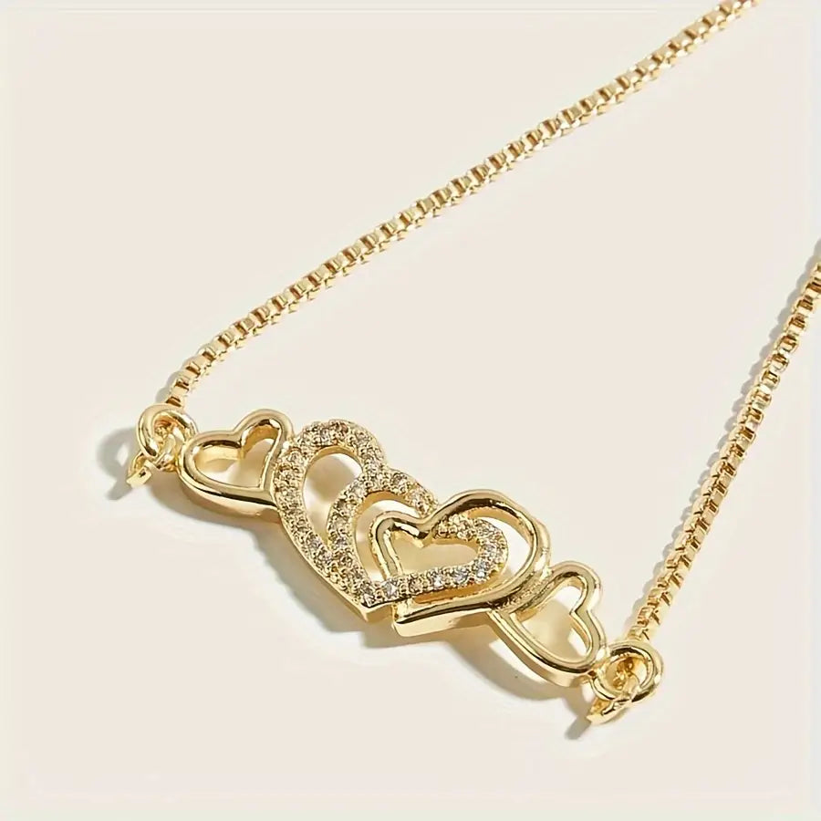 Gold-Tone Bracelet with Dazzling Heart Charms